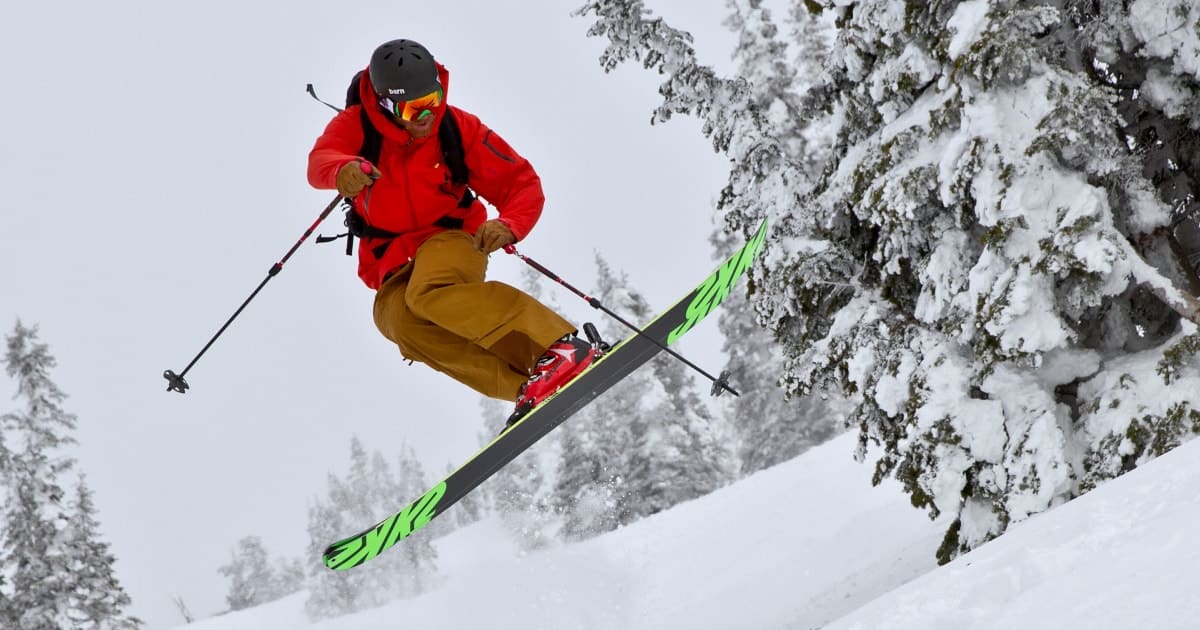 Base Mountain Sports skiier jumping on snow covered mountain