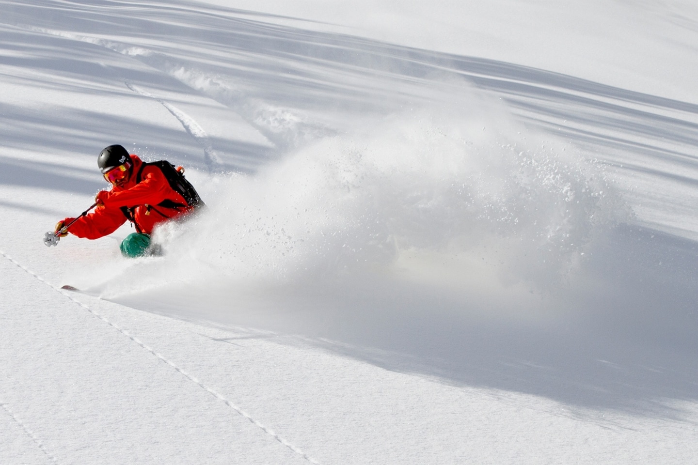 Skier carving through fresh snow on Colorado mountain